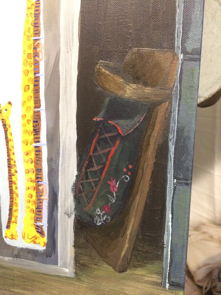 A detail of an unfinished painting shows a Tiginaagan tucked away in a closet and leaning up against a filing cabinet.