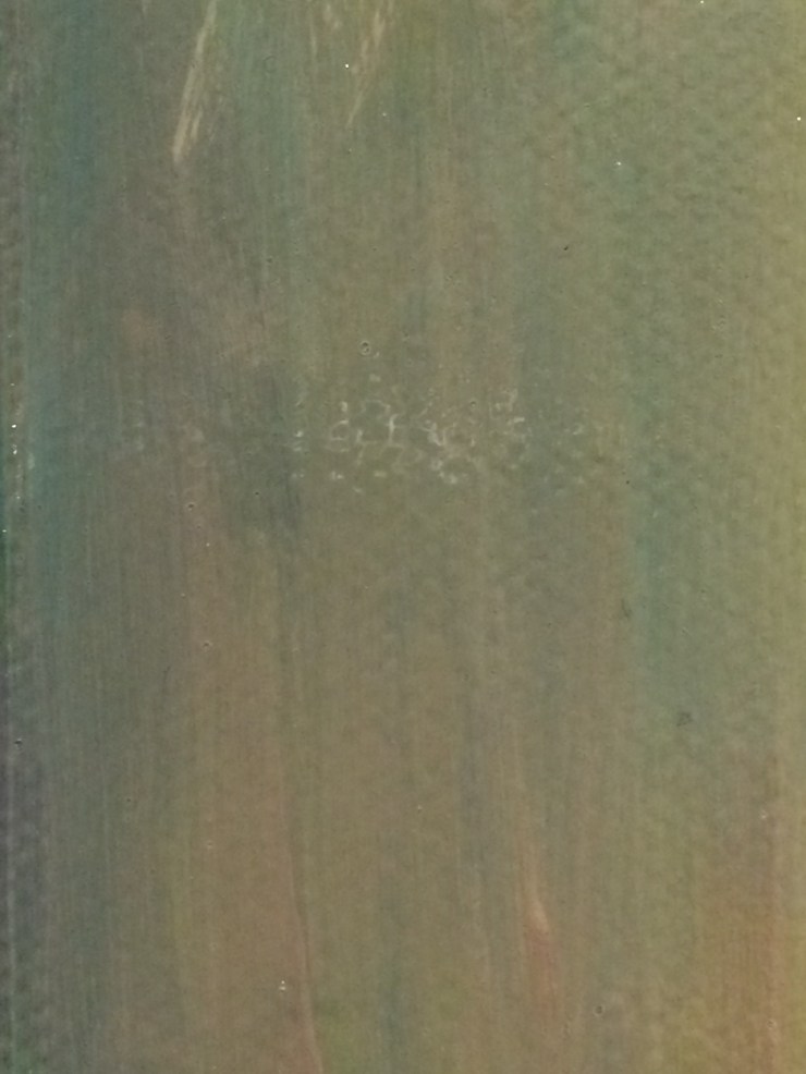 a close up of brush stokes of greenish grey paint.